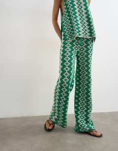 Model wearing Knitted patterned crochet look co-ord trouser in green and white
