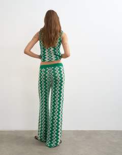 Model wearing Knitted patterned crochet look co-ord trouser in green and white