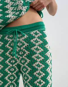 Model wearing Knitted patterned crochet look co-ord trouser in green and white