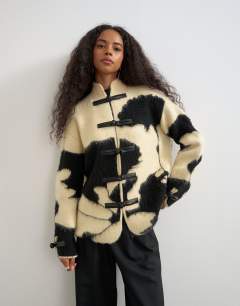 Knitted patterned frogging detail jacket in black and cream