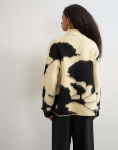 Model wearing Knitted patterned frogging detail jacket in black and white