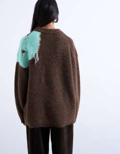 Model wearing Knitted placement floral tassel jumper in chocolate