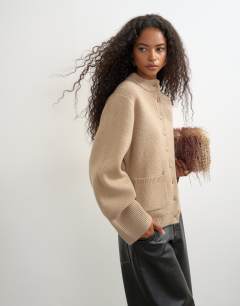 Model wearing Knitted pocket front cardigan in oat