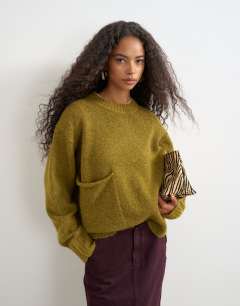 Model wearing Knitted pocket jumper in corn