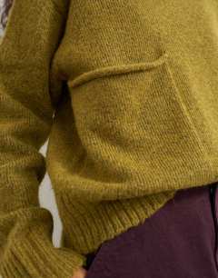 Model wearing Knitted pocket jumper in corn