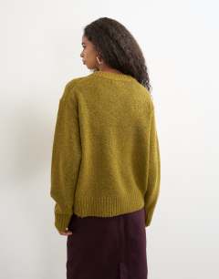 Model wearing Knitted pocket jumper in corn