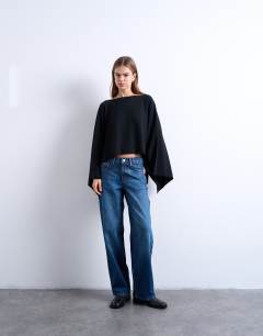 Model wearing Knitted poncho in black