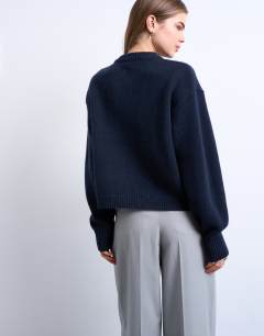 Model wearing Knitted premium 100% lambswool cardigan in navy