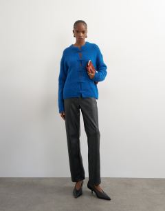 Model wearing Knitted premium alpaca blend frogging detail cardigan in blue