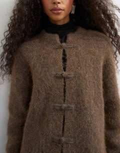 Model wearing Knitted premium alpaca blend frogging detail cardigan in dark brown