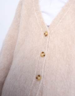 Model wearing Knitted premium alpaca cardigan in beige