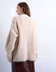 Model wearing Knitted premium alpaca cardigan in beige
