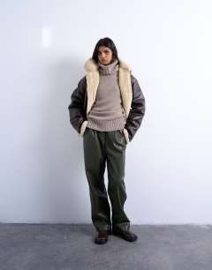 Model wearing Knitted premium cashmere roll neck jumper in oat