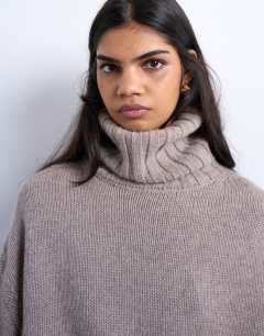 Model wearing Knitted premium cashmere roll neck jumper in oat