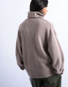 Model wearing Knitted premium cashmere roll neck jumper in oat
