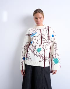 Model wearing Knitted premium oversized embroidered jumper in ivory