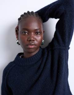Model wearing Knitted raglan exposed seam jumper in navy