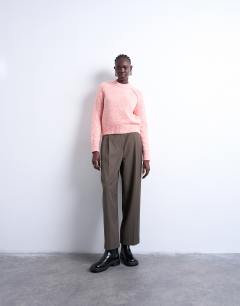 Model wearing Knitted raglan exposed seam jumper in pink