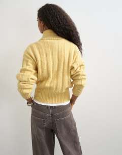 Model wearing Knitted rib funnel neck jumper in eggnog