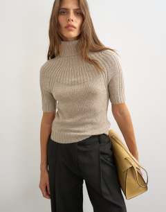 Model wearing Knitted rib yoke funnel neck top in oat