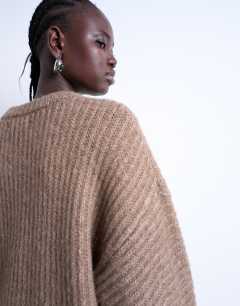 Model wearing Knitted ribbed balloon sleeve jumper in brown