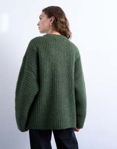 Model wearing Knitted ribbed balloon sleeve jumper in green