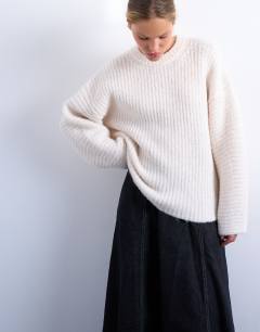 Model wearing Knitted ribbed balloon sleeve jumper in ivory