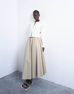 Model wearing Knitted ribbed button crew cardigan in white