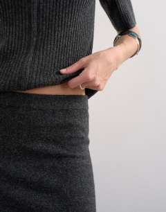 Model wearing Knitted ribbed co-ord skirt in charcoal