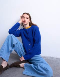 Model wearing Knitted ribbed crew relaxed button cardigan in blue