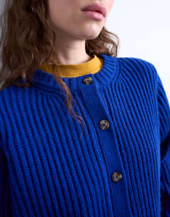 Model wearing Knitted ribbed crew relaxed button cardigan in blue