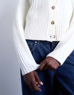 Model wearing Knitted ribbed crew relaxed button cardigan in white