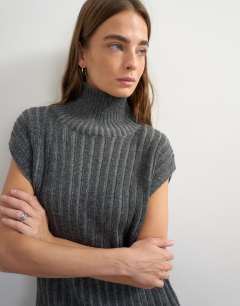 Model wearing Knitted ribbed funnel neck wool longline top with tube hem in coal