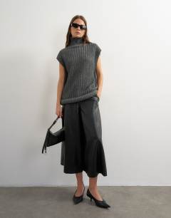 Model wearing Knitted ribbed funnel neck wool longline top with tube hem in coal