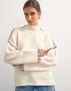 Model wearing Knitted roll edge blanket stitch jumper in ivory