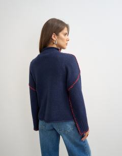 Model wearing Knitted roll edge blanket stitch jumper in navy
