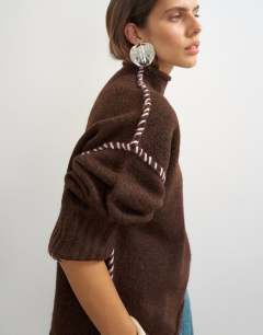 Model wearing Knitted roll edge blanket stitch jumper in pecan