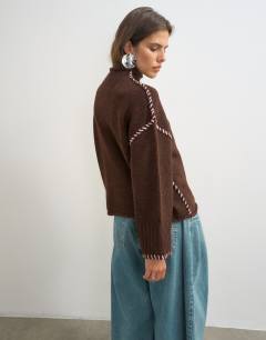 Model wearing Knitted roll edge blanket stitch jumper in pecan