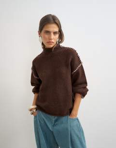 Model wearing Knitted roll edge blanket stitch jumper in pecan