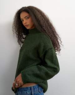 Model wearing Knitted roll edge longline chunky jumper with wool in olive