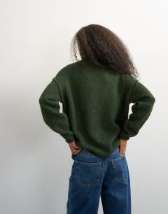 Model wearing Knitted roll edge longline chunky jumper with wool in olive