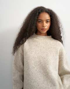 Model wearing Knitted roll edge relaxed fit jumper with wool in oat