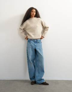 Model wearing Knitted roll edge relaxed fit jumper with wool in oat