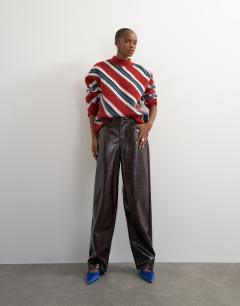 Model wearing Knitted roll edge stripe jumper in red multi