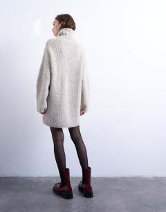 Model wearing Knitted roll neck mini dress in oat