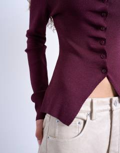 Model wearing Knitted ruffle button long sleeve top in plum purple
