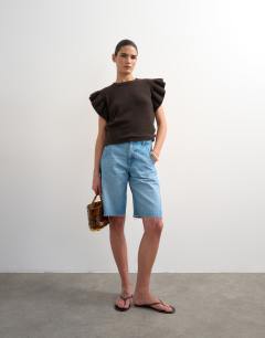 Model wearing Knitted Ruffle Short Sleeve Top in Brown