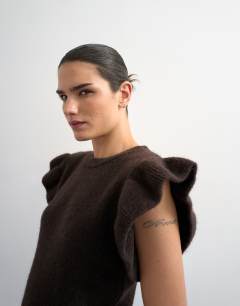 Model wearing Knitted Ruffle Short Sleeve Top in Brown