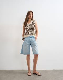 Model wearing Knitted scoop neck animal vest in ivory