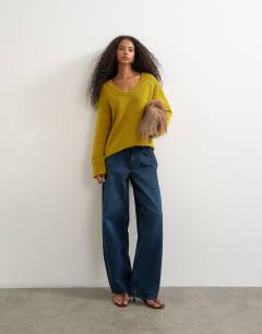Model wearing Knitted scoop neck jumper in corn